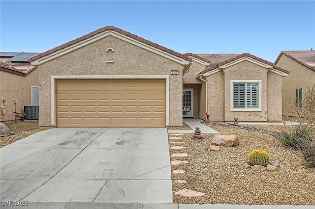 single story home featuring a garage, a tiled roof, driveway, and stucco siding