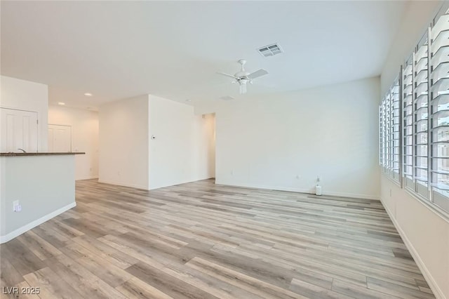 unfurnished living room featuring ceiling fan, recessed lighting, visible vents, baseboards, and light wood-type flooring