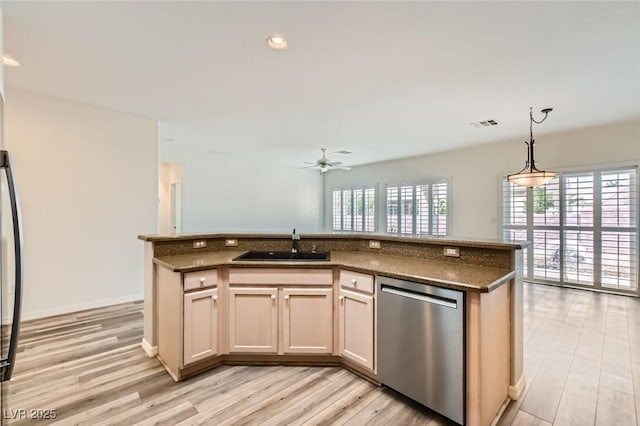 kitchen with a healthy amount of sunlight, dishwasher, light wood-style flooring, and a sink