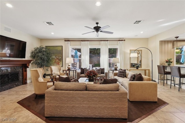 3863 Glasgow Green Dr, Las Vegas, NV 89141 - living area featuring tile patterned floors, visible vents, a ceiling fan, and a premium fireplace