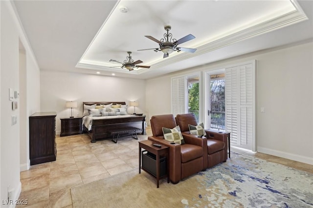 bedroom with ornamental molding, a tray ceiling, a ceiling fan, and baseboards