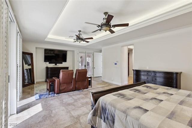 bedroom with ceiling fan, a tray ceiling, ornamental molding, and baseboards