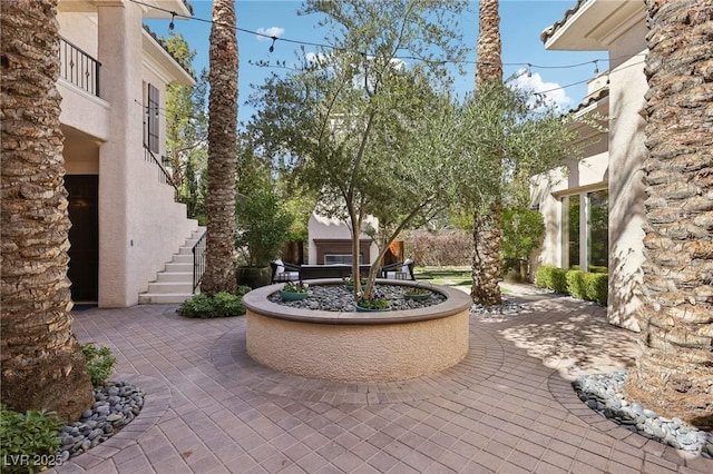 view of home's community featuring a patio area and stairway