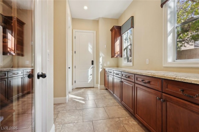 interior space featuring light tile patterned floors and baseboards