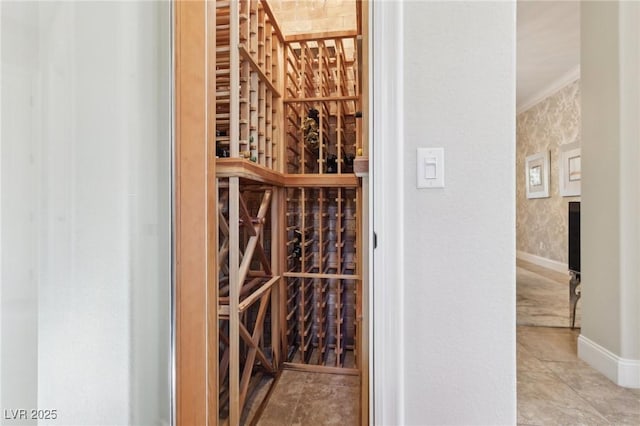 wine area featuring ornamental molding and baseboards