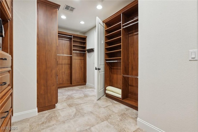 spacious closet featuring visible vents