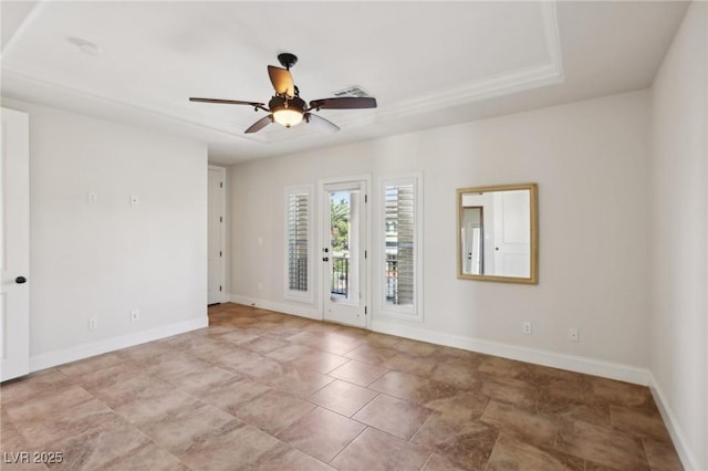 spare room with visible vents, a ceiling fan, and baseboards