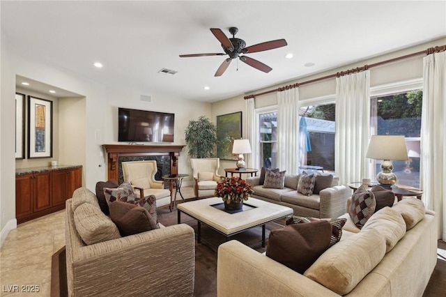 living area featuring ceiling fan, visible vents, and recessed lighting