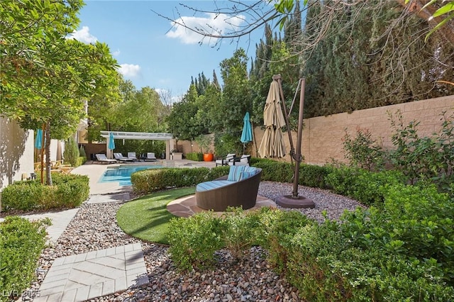 view of yard with a patio, a fenced backyard, a fenced in pool, and a pergola