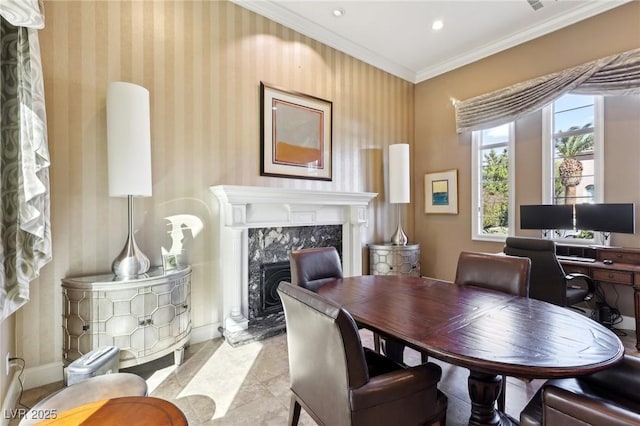 dining space with recessed lighting, a fireplace, baseboards, wallpapered walls, and crown molding