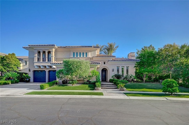 3863 Glasgow Green Dr, Las Vegas, NV 89141 - mediterranean / spanish-style house featuring an attached garage, driveway, a tile roof, stucco siding, and a chimney
