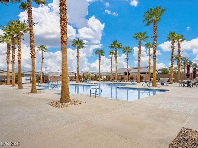 pool featuring fence and a patio