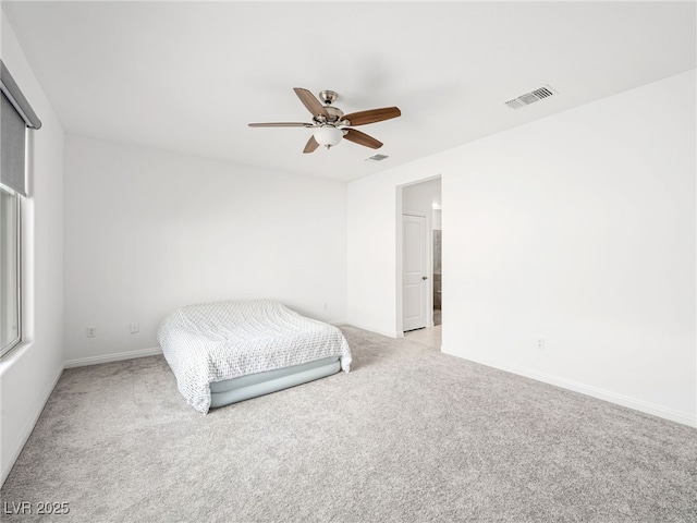 unfurnished bedroom with light carpet, visible vents, and baseboards