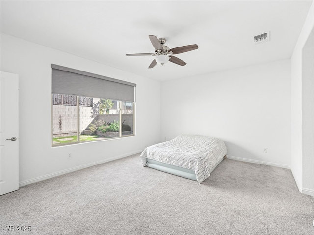 carpeted bedroom featuring baseboards, visible vents, and a ceiling fan