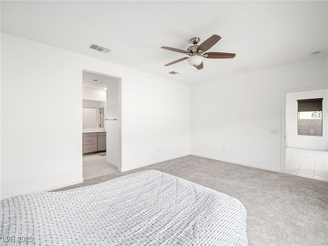 unfurnished bedroom with baseboards, visible vents, light colored carpet, ceiling fan, and light tile patterned flooring