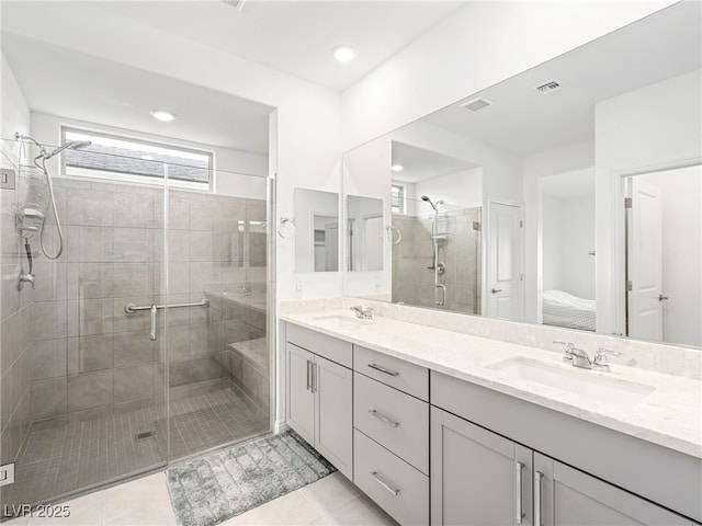 bathroom featuring a sink, visible vents, and a shower stall