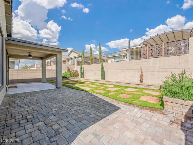 view of patio featuring ceiling fan and a fenced backyard