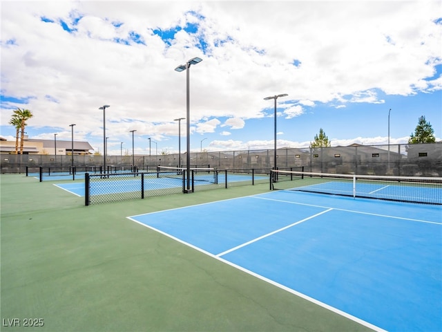 view of tennis court featuring fence