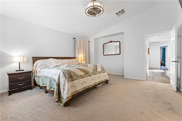 bedroom with vaulted ceiling, carpet flooring, baseboards, and visible vents