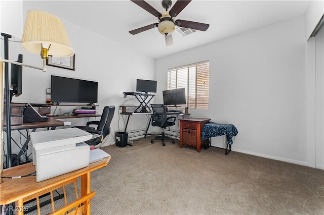 carpeted office with visible vents, baseboards, lofted ceiling, and a ceiling fan