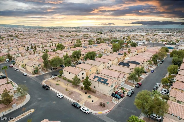 aerial view at dusk featuring a residential view