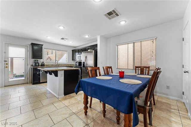 dining space featuring light tile patterned flooring, recessed lighting, visible vents, and baseboards