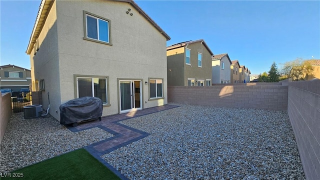 rear view of property with a patio, a fenced backyard, and stucco siding