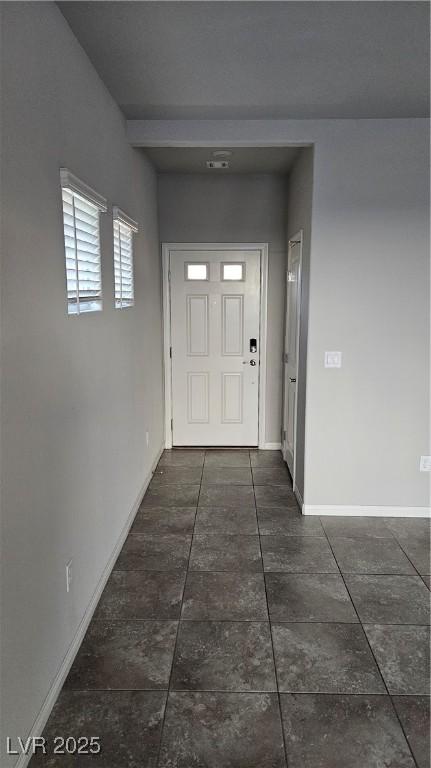 hallway featuring baseboards