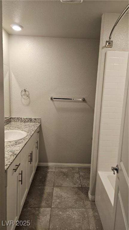 full bath featuring baseboards, shower / tub combo with curtain, and vanity