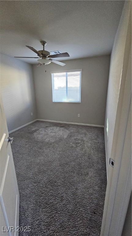 spare room with visible vents, baseboards, ceiling fan, carpet, and a textured ceiling