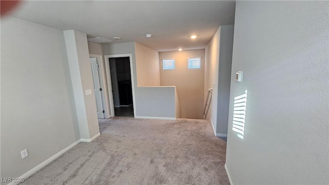 carpeted empty room with baseboards