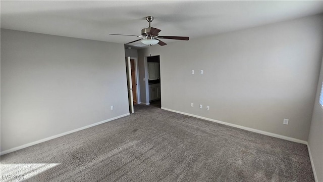 spare room with a ceiling fan, carpet, and baseboards