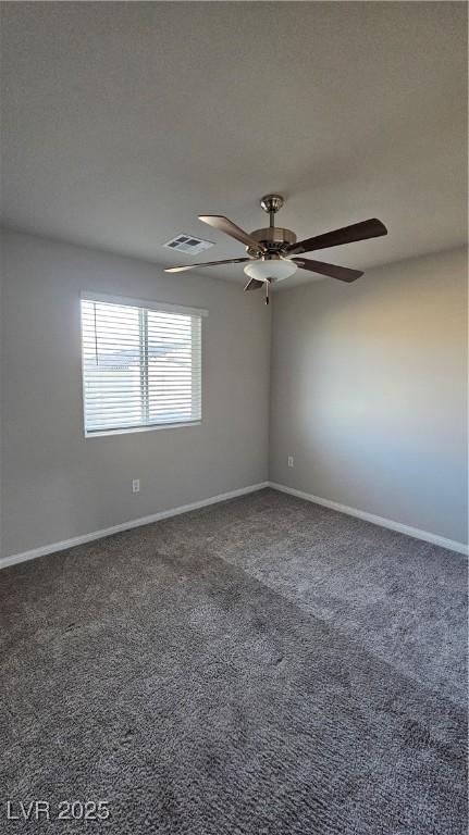 carpeted spare room with visible vents, ceiling fan, a textured ceiling, and baseboards