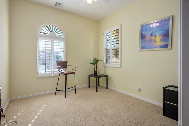 interior space featuring a ceiling fan, carpet, visible vents, and baseboards