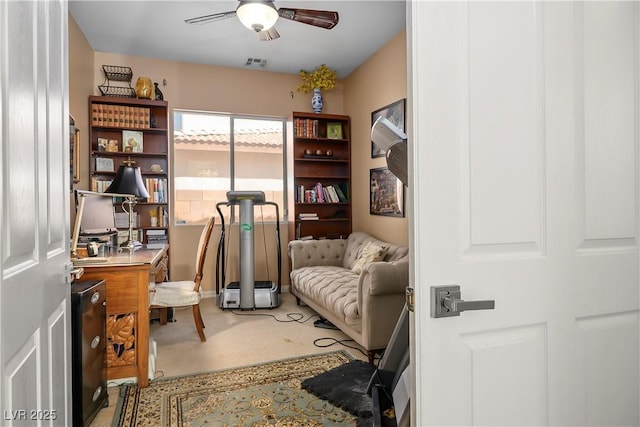 carpeted home office featuring ceiling fan and visible vents