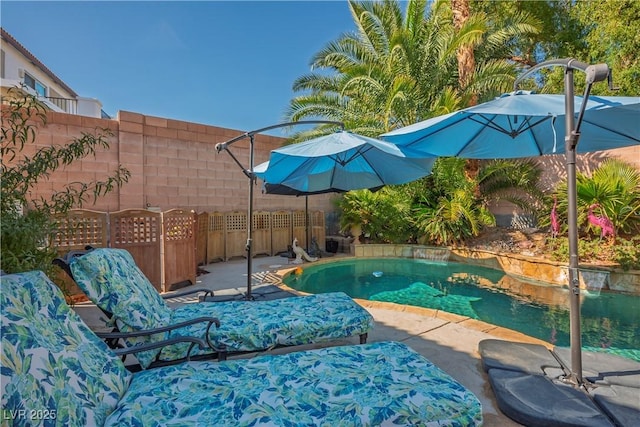 outdoor pool featuring a patio area and fence