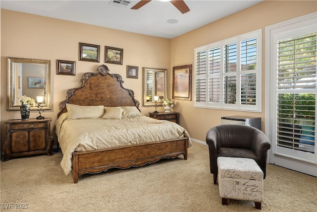 carpeted bedroom with multiple windows, ceiling fan, visible vents, and baseboards