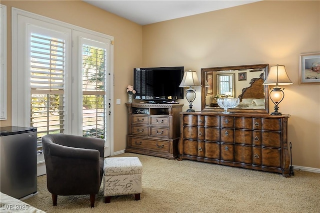 sitting room featuring carpet floors and baseboards