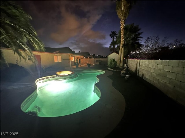 view of pool with a pool with connected hot tub and a fenced backyard