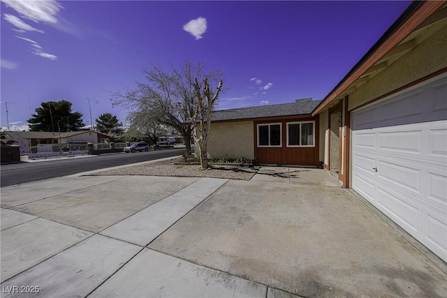 view of side of property with a garage and driveway