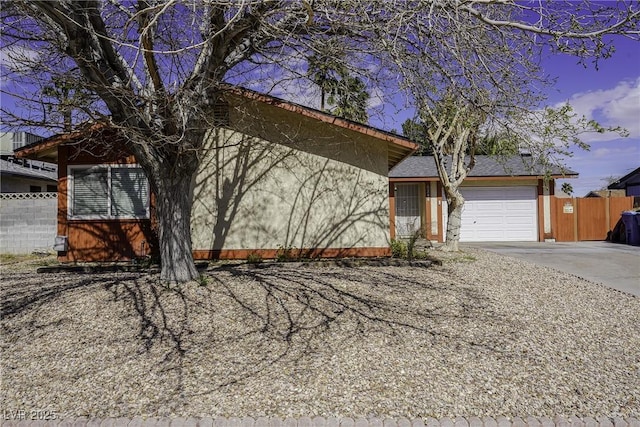 single story home featuring a garage, fence, and driveway