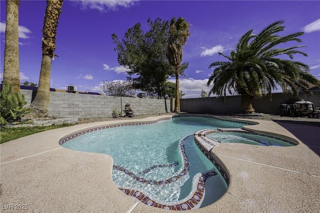 view of pool featuring a fenced backyard and a pool with connected hot tub