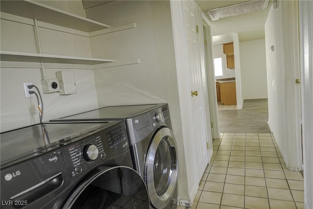 washroom with laundry area, light tile patterned flooring, visible vents, and washer and dryer