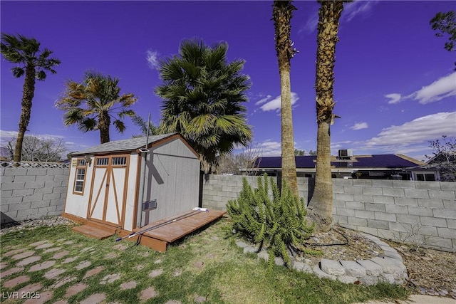 view of shed featuring a fenced backyard