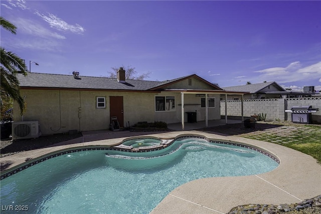 view of pool featuring ac unit, grilling area, fence, a patio area, and a pool with connected hot tub