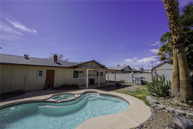 view of pool with a pool with connected hot tub, a patio area, fence, and grilling area