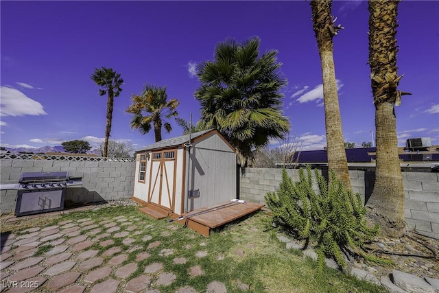 view of shed with a fenced backyard