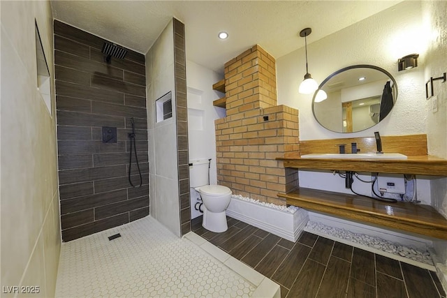 full bathroom with recessed lighting, toilet, wood tiled floor, a sink, and walk in shower