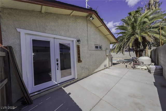 exterior space featuring french doors and fence