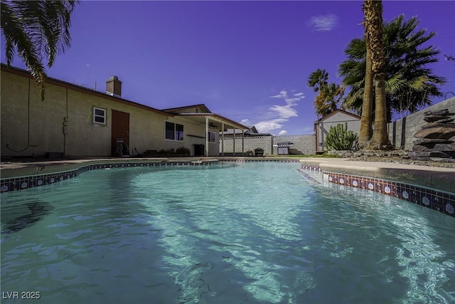 view of swimming pool featuring a fenced in pool and fence